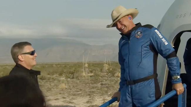 Blue Origin founder Jeff Bezos leaves the New Shepard craft capsule after it returned from space, safely landing on Tuesday in Van Horn, Texas. Picture: AFP / Blue Origin