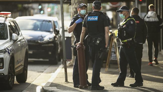 There was a heavy police presence along Swan Street in Richmond before the AFL Grand Final was won by the Richmond team on Saturday night. Authorities were keen to keep pandemic restrictions in force amid the cause for excitement. <a href="https://www.theaustralian.com.au/sport/afl/2020-afl-grand-final-live-gabba-drenched-fears-of-delays-for-historic-decider/news-story/01f2b0fa59f617dc95bf538a55d75936">Read match report.</a> Picture: Getty Images