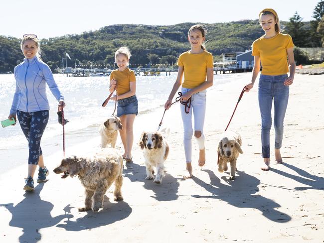 Dog owner Ali Williams and friends Isabelle Johnston, 11, Alexandra Sarmiento, 11, and Caitlin Harbot, 11, are supporters of making part of Station Beach, opposite Palm Beach, an off-leash dog area. Picture: Dylan Robinson