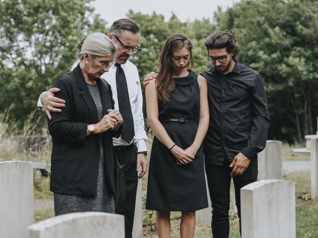 Family giving their last goodbyes at the cemetery