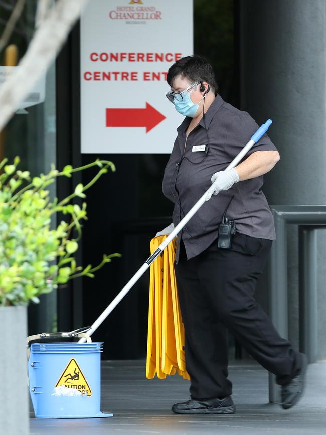 A cleaner in PPE mopping the floor at the Hotel Grand Chancellor in Brisbane. Picture: Liam Kidston