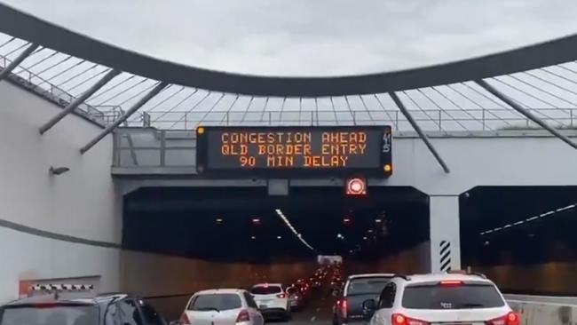 Signage warning motorists cross the border into Queensland of 90 minute delays.