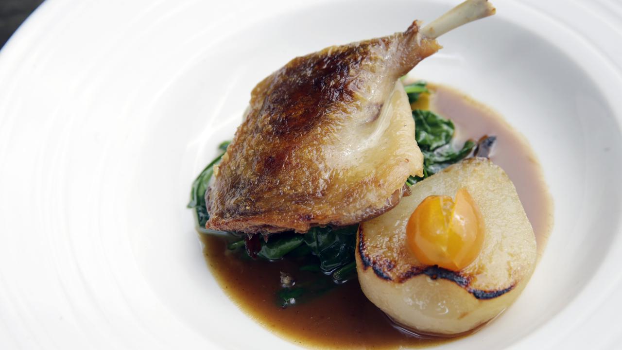 Confit Duck with bay leaf, poached pear, cumquats and spinach. Picture: Lachie Millard