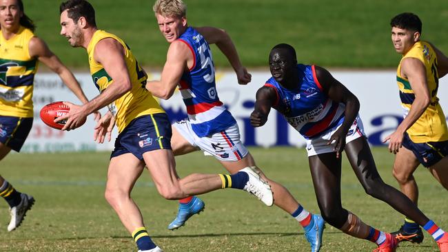 Central District’s Leek Alleer chases Eagle Daniel Menzel at Elizabeth Oval on Saturday. Picture: Naomi Jellicoe