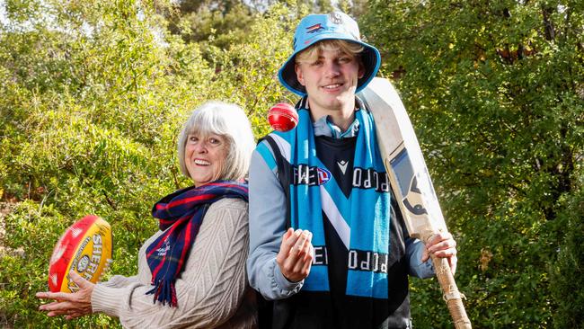 Sports fans through the generations: Grandma Pattie Miles, 75, a traditional 'one-eyed' Crows supporter and tech-savvy grandson Jack Runner, 16 … who barracks for Port and fan worships Mitch Georgiades (#19). Picture: Image/Russell Millard Photography