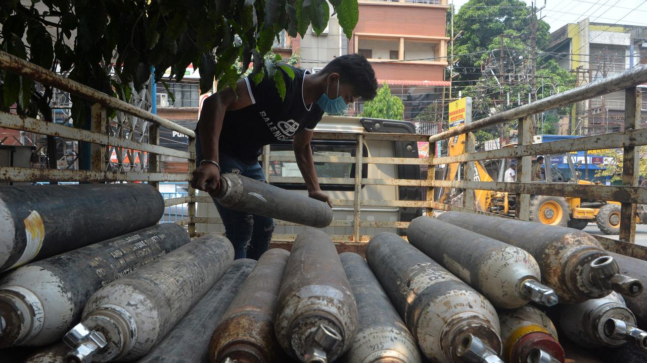 A man unloads empty oxygen cylinders for refill at an oxygen supply agency amid rising Covid-19 coronavirus cases in India. Picture: Diptendu DuttaAFP