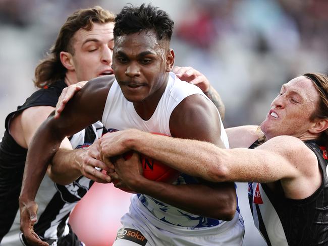 MELBOURNE.  09/07/2022 . AFL . Round 17.    Collingwood vs North Melbourne at the MCG.  Phoenix Spicer of the Kangaroos tries to charge through the tacklers during the 1st qtr.    . Photo by Michael Klein