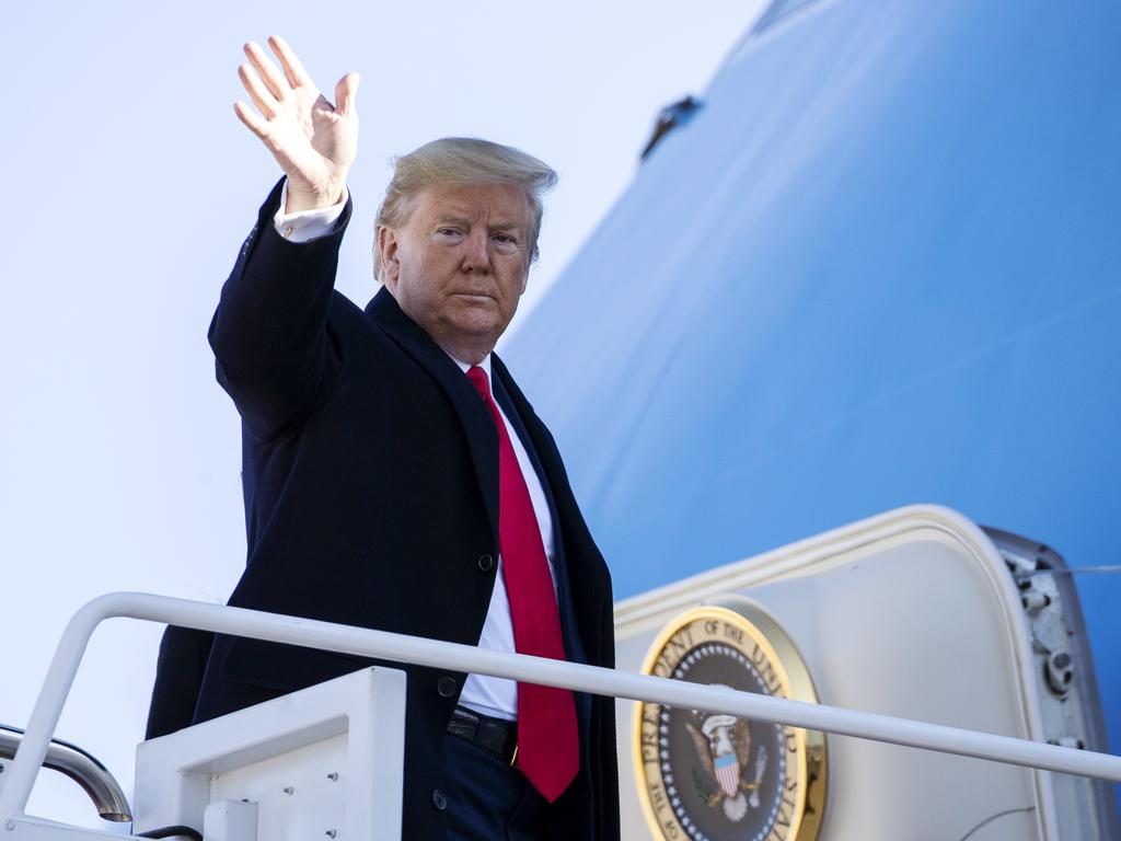 Donald Trump waves as he boards Air Force One to depart for India. Picture: AP Photo/Alex Brandon