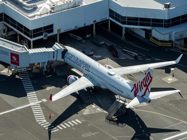 SYDNEY, AUSTRALIA - APRIL 22: Virgin Australia planes are grounded at Sydney Domestic Airport on April 22, 2020 in Sydney, Australia. Restrictions have been placed on all non-essential business and strict social distancing rules are in place across Australia in response to the COVID-19 pandemic.  (Photo by Cameron Spencer/Getty Images)