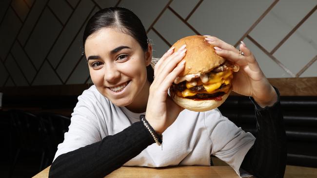 Georgia Ross, 19 of Sandy Bay enjoys the Tomahawk burger from Burger Got Soul. Picture: Zak Simmonds