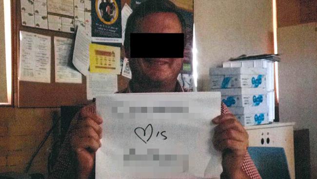 The teacher allegedly holding up the sign mentioned in the teenage student’s statement of claim. Picture: Supplied