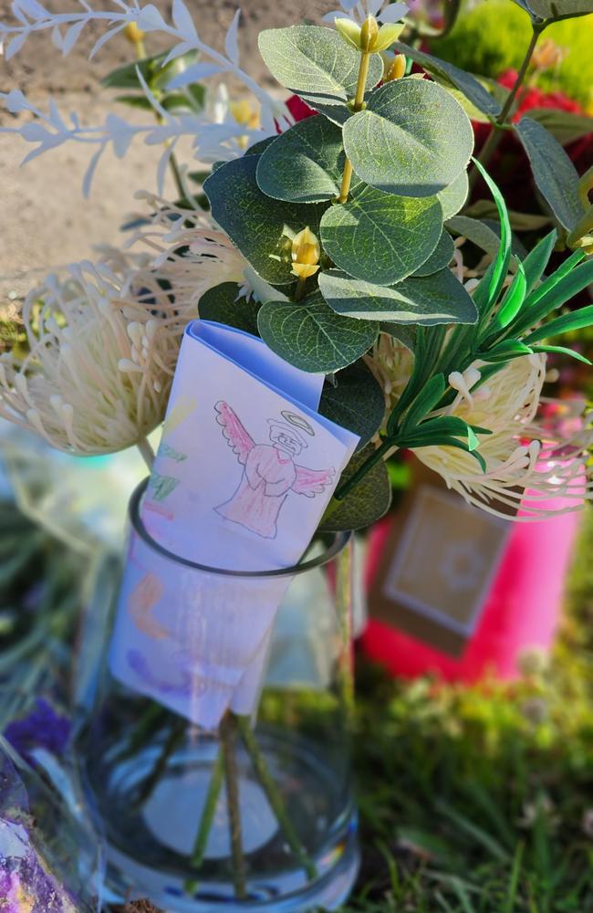 Flowers and notes handwritten by children can be seen at the school crossing where a 52-year-old woman was killed. PHOTO: Mark Furler