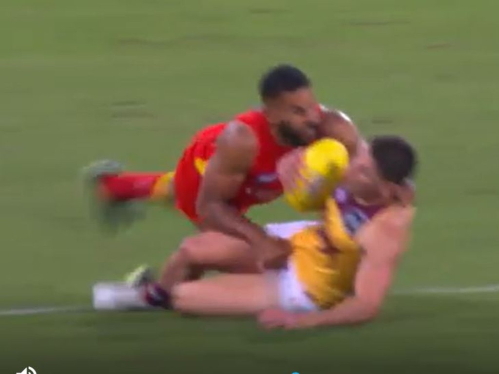 Touk Miller tackles Dayne Zorko.