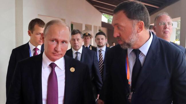 Russia's President Vladimir Putin, left, and Russian metals magnate Oleg Deripaska, right. Picture: AP