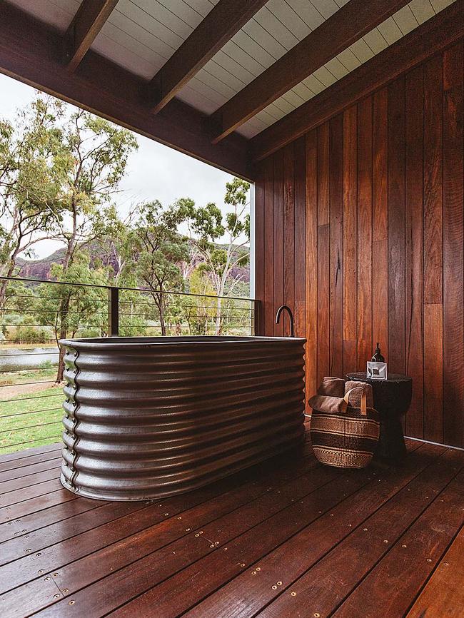 A corrugated iron bathtub looks over the weir at Mount Mulligan Lodge.