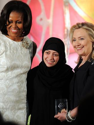 Michelle Obama and Hillary Clinton present women’s rights activist Samar Badawi with the 2012 International Women of Courage Award. Picture: Jewel Samad