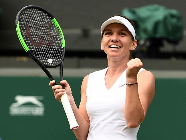 Romania's Simona Halep celebrates beating Ukraine's Elina Svitolina during their women's singles semi-final match on day ten of the 2019 Wimbledon Championships at The All England Lawn Tennis Club in Wimbledon, southwest London, on July 11, 2019. (Photo by Daniel LEAL-OLIVAS / AFP) / RESTRICTED TO EDITORIAL USE