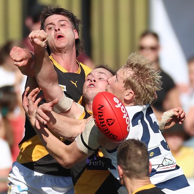 Albury players punch the ball clear of Yarrawonga’s Leigh Williams.