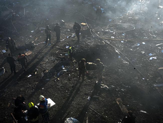 Rescuers and policemen work at a site of a Russian strike in Kharkiv on March 7, 2025, amid the Russian invasion of Ukraine. The Ukrainian air force said Russia had launched at least 58 missiles and nearly 200 drones, damaging energy facilities across the country from Kharkiv in the east to Ternopil in the west. Picture: AFP