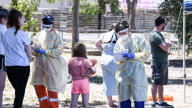 Medical staff talk to people at a walk in station at Parafield Airport in Adelaide. Picture: AFP