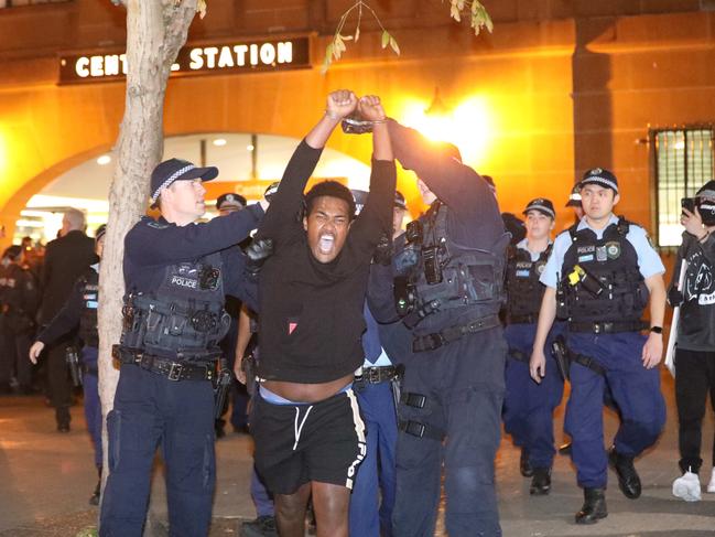 A protester is being led away by police at Central Station. Picture: Damian Shaw