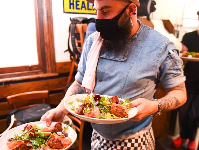 Chefs prepare meals for testing during a staff orientation day as Tiamo Bistro readies for opening in Melbourne on October 27, 2020, as the state government lifts some restrictions on retail and restaurants after the city battled a second wave of the Covid-19 coronavirus. (Photo by William WEST / AFP)