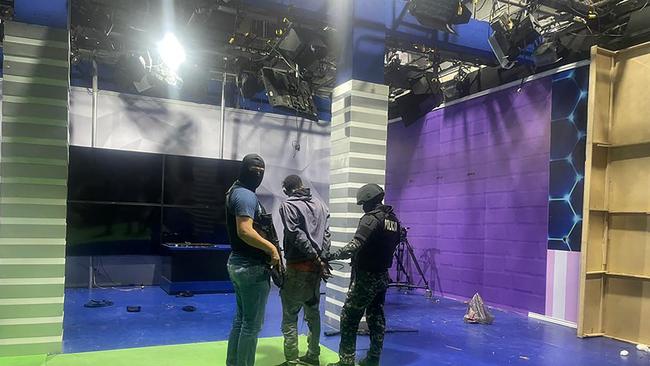 Police officers arrest one of the unidentified gunmen who burst into a studio of the state-owned TC television while live, in Guayaquil, Ecuador. Picture: AFP