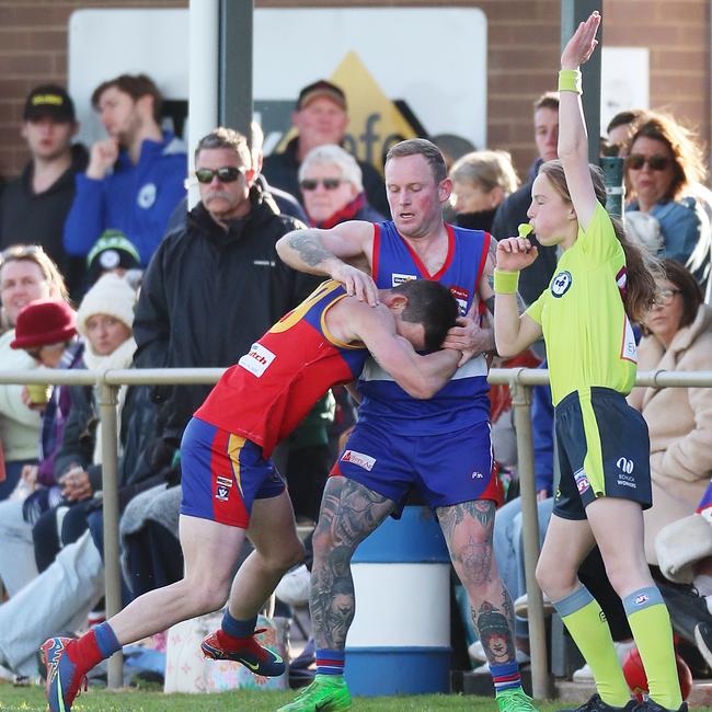 Pyramid Hill’s Ben Knight and Marong’s Nathan Devanny tangle near the boundary line.