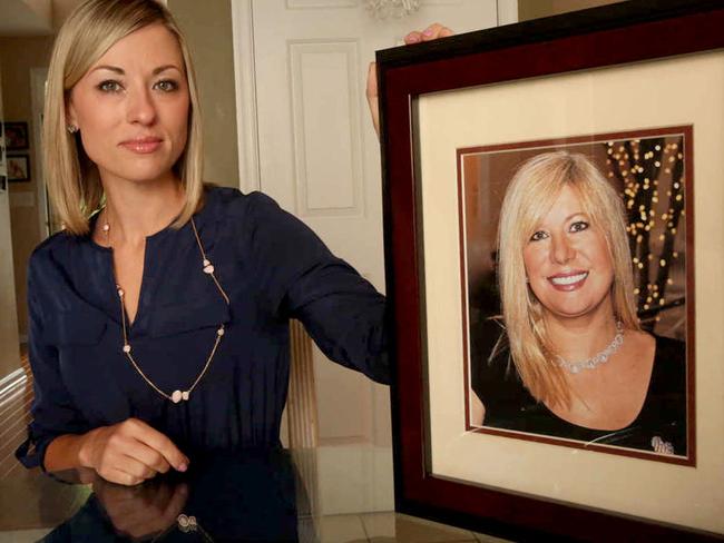 Kim Pack poses with a photo of her late mother, talk-show host April Kauffman. Picture: AP
