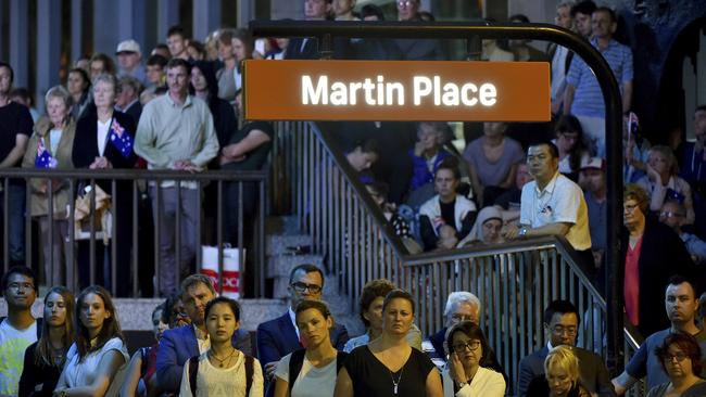 Members of the public listen to a memorial service marking the first anniversary of Lindt Cafe Siege in Martin Place, Sydney, Australia. Picture: Saeed Khan/Pool Photo via AP