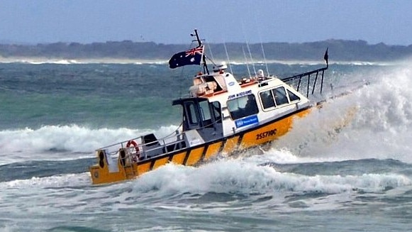 Noosa Coast Guard vessel John Waddams crossing the bar after a week of strong winds and big swells.