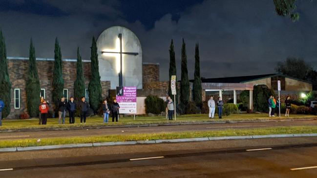 People gather outside St Leonard’s Catholic Church to watch the superload on July 13, 2022. Picture: Kiel Egging.