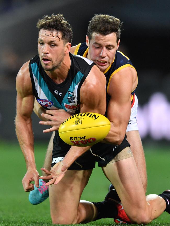 Luke Brown wraps up Port captain Travis Boak. Picture: AAP Image/David Mariuz