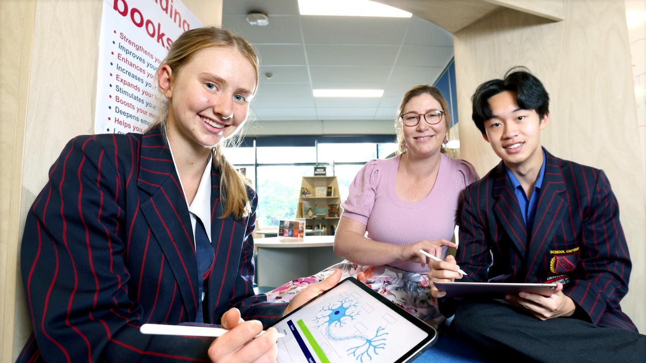 Brisbane State High School students Indi Fletcher and Harris Zhong with teacher Aliska Bierman are taking part in the AI trial. Picture: Steve Pohlner