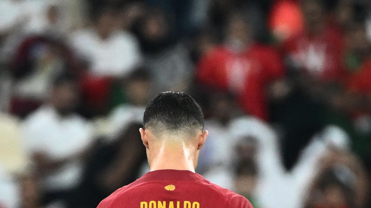 Portugal's forward #07 Cristiano Ronaldo looks down after qualifying to the next round after defeating Switzerland 6-1 in the Qatar 2022 World Cup round of 16 football match between Portugal and Switzerland at Lusail Stadium in Lusail, north of Doha on December 6, 2022. (Photo by Jewel SAMAD / AFP)