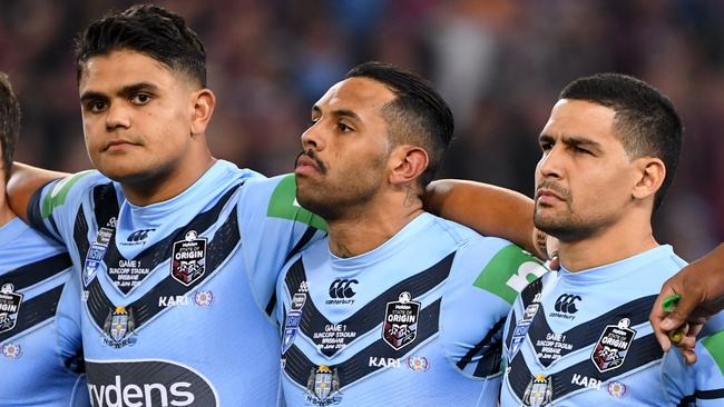 Latrell Mitchell, Josh Addo-Carr and Cody Walker look on during the national anthem. Image: AAP Image/Dave Hunt