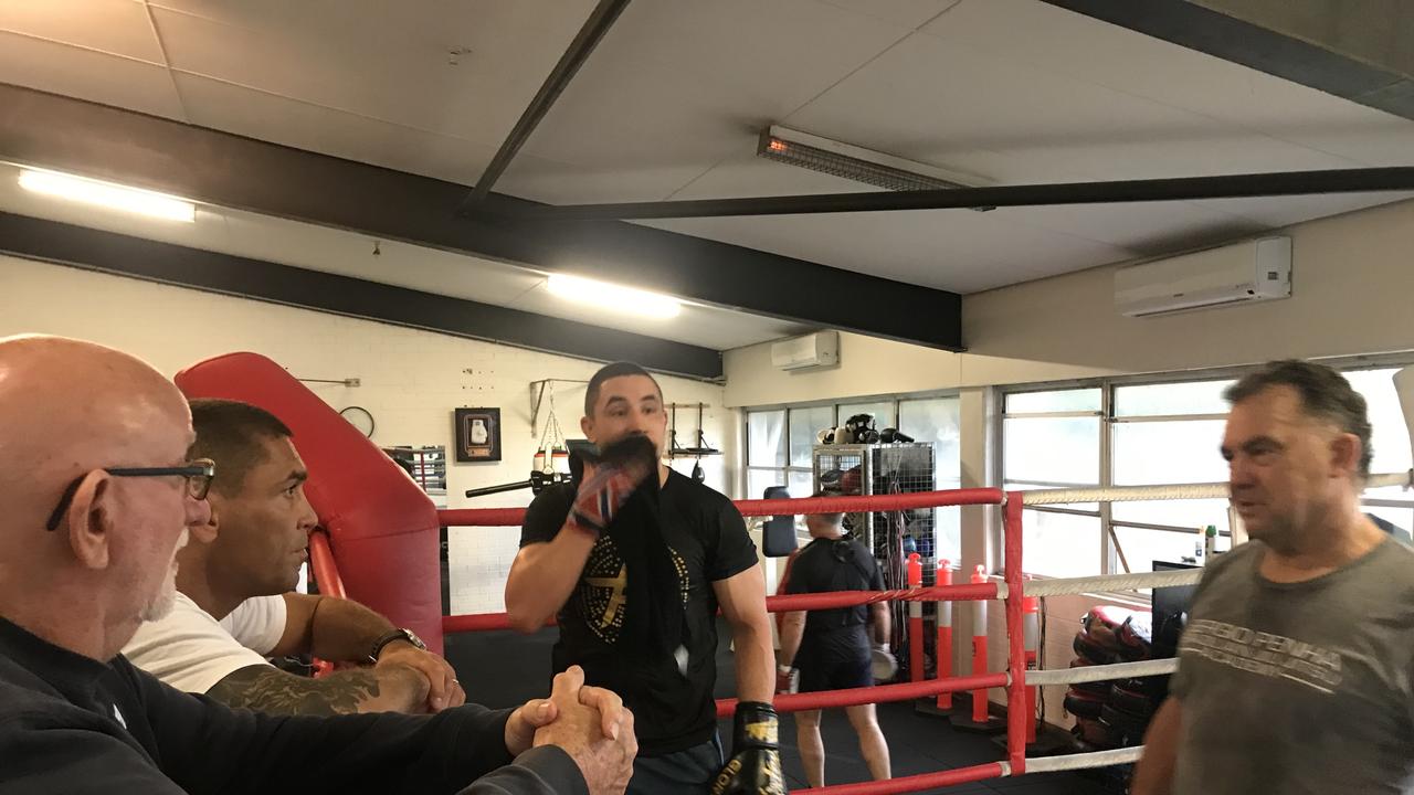 Johnny Lewis pauses a Whittaker padwork session to offer advice.