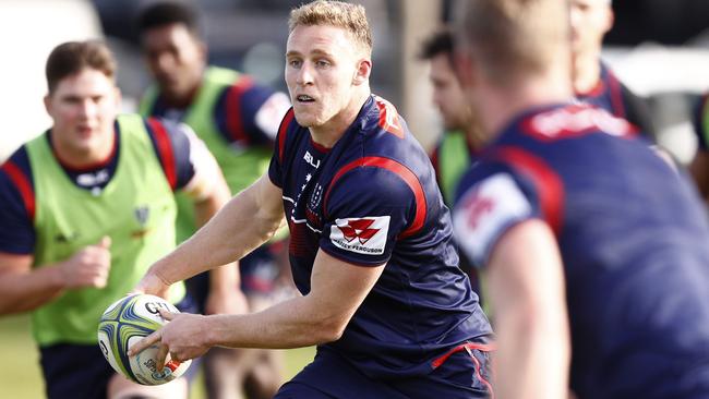 Rebels player Reece Hodge passes a ball during a team training session in Melbourne.