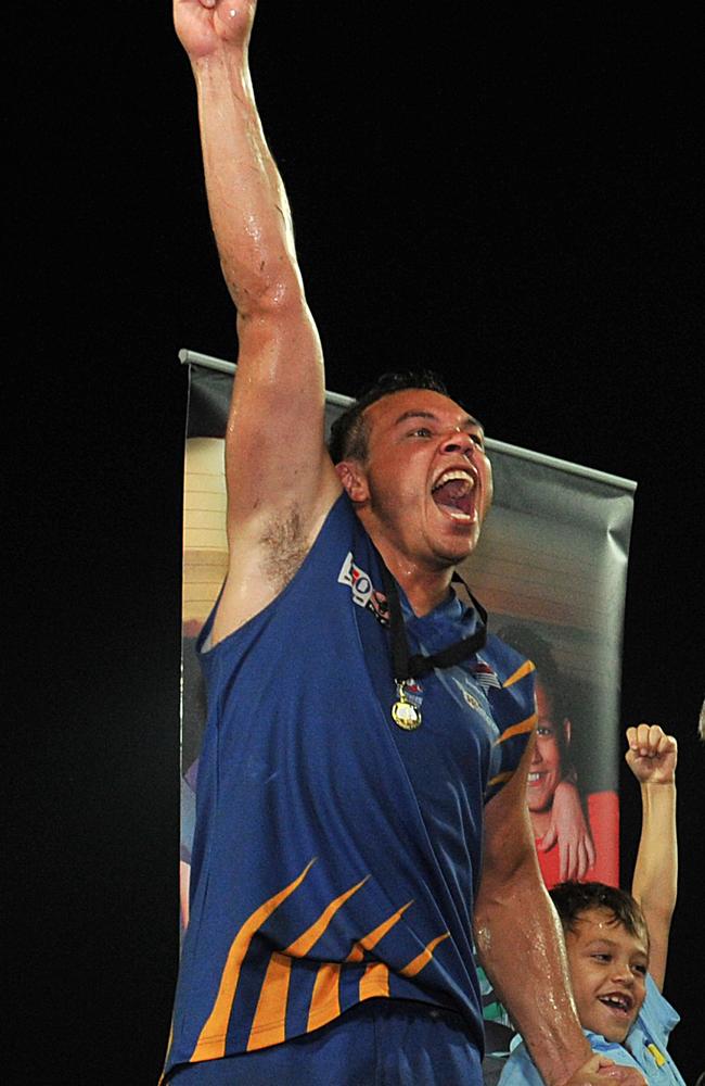 Shannon Motlop celebrates the 2011 NTFL premiership title at the TIO stadium.