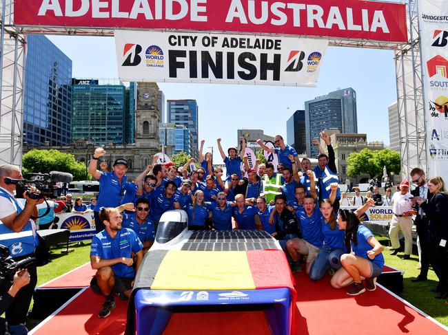 The Belgian solar car team Agoria celebate after their car was first to cross the finish line. Picture: AAP / David Mariuz