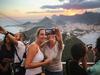 RIO DE JANEIRO, BRAZIL - FEBRUARY 23: People take selfies at the summit of Sugarloaf (Pao de Acucar) on February 23, 2015 in Rio de Janeiro, Brazil. The original Sugarloaf cable car line was constructed in 1912 and links riders to the peak of the granite rock formation which rises 1,300 feet above Guanabara Bay. Rio marks its 450th anniversary on March 1 and is celebrating the event with a yearlong series of events including concerts, exhibitions, historical tours, soccer matches, fireworks displays and other activities. The 'Marvelous City' was founded in 1565 by the Portuguese and was the seat of power of the Portuguese Empire in the 19th century before serving as the capital of the Brazilian Republic until 1960. The city is Brazil's most popular tourist destination and will host the Rio 2016 Olympic Games, the first to be held in South America, next year. (Photo by Mario Tama/Getty Images)