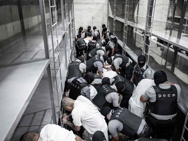 The arrival of alleged members of the Venezuelan criminal organisation Tren de Aragua at the mega-prison. Picture: AFP