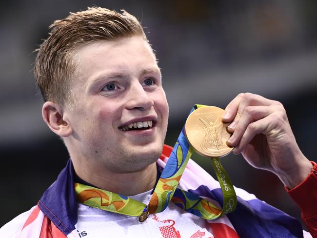 Adam Peaty shows off his gold after breaking the world record in Rio. Picture: AFP