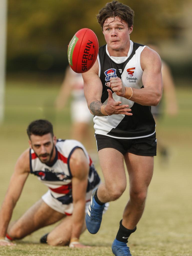 Southern: Jacob Bakes of Oakleigh District gets the handball away. Picture: Valeriu Campan