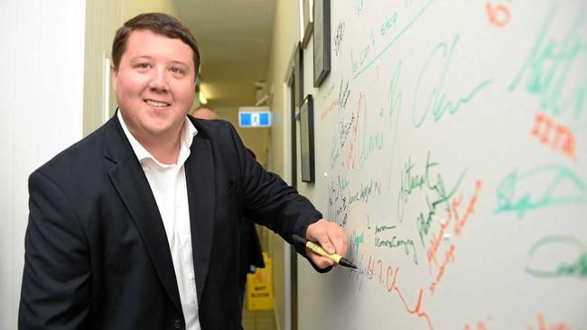 Cr. Reece Byrnes signs the wall at The Right Food Group company. Picture: Scott Davis