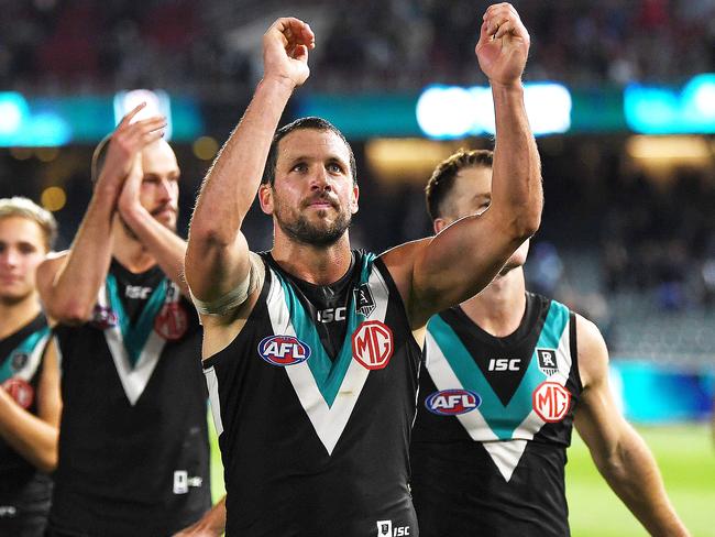 ADELAIDE, AUSTRALIA - AUGUST 08: Travis Boak of Port Adelaide   celebrates the win with the fans during the round 11 AFL match between the Port Adelaide Power and the Richmond Tigers at Adelaide Oval on August 08, 2020 in Adelaide, Australia. (Photo by Mark Brake/Getty Images)