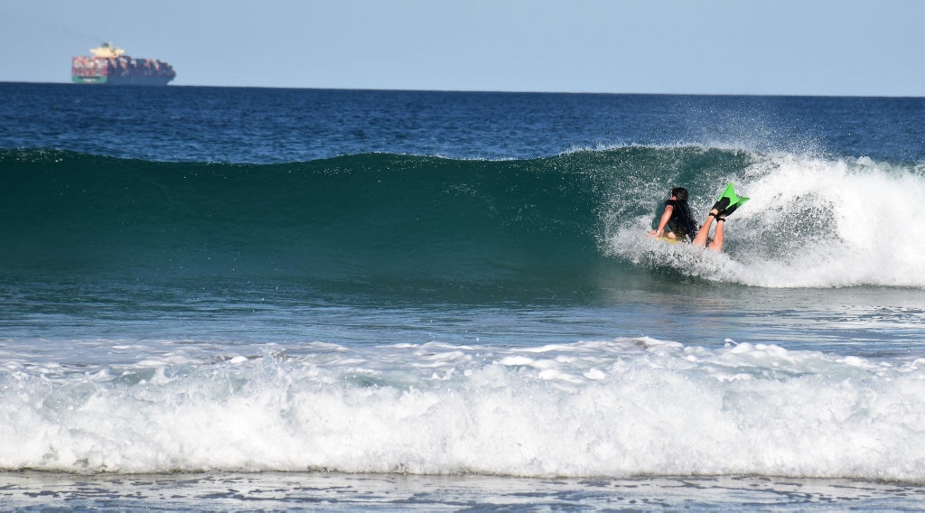 Surfers and bodyboard riders making the most of the waves at Kawana on the weekend. Picture: Mark Furler