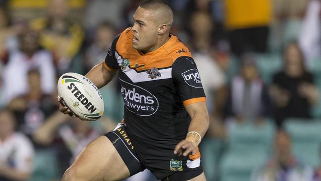 Tuimoala Lolohea races away to score a try for the Tigers against the Warriors at Leichhardt Oval.