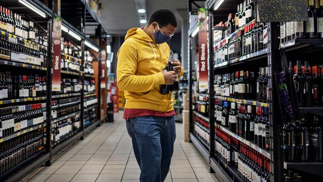 A customer buys alcohol at a liquor shop in Craighall Park, Johannesburg. Picture: AFP