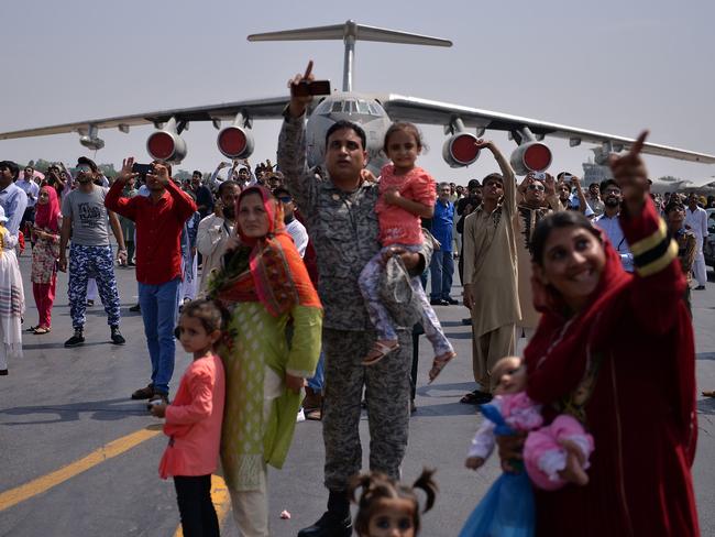 Pakistanis watch a F-16 fighter perform during celebrations to mark Defence Day at the Nur Khan military air base in Islamabad, 2017. Picture: AFP Photo/Aamir Qureshi